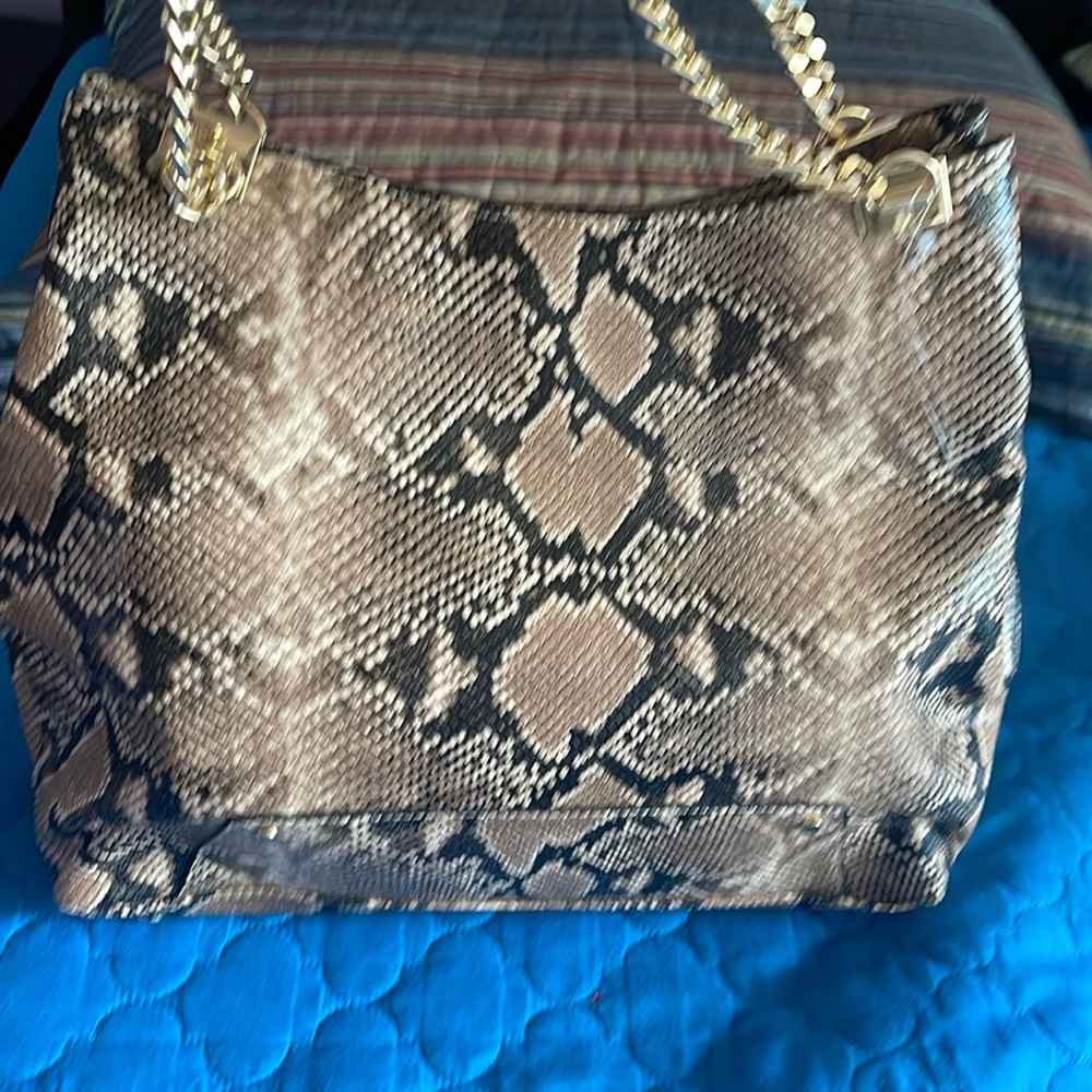 INC International Concepts® tote features gleaming chain-detail straps.